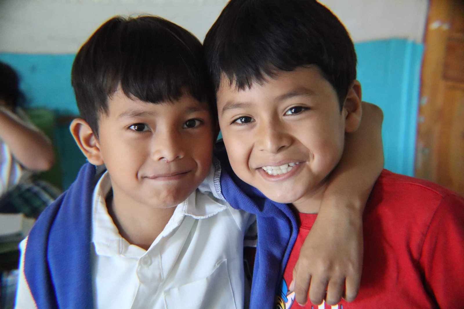Two children embracing each other warmly, sharing a moment of friendship
