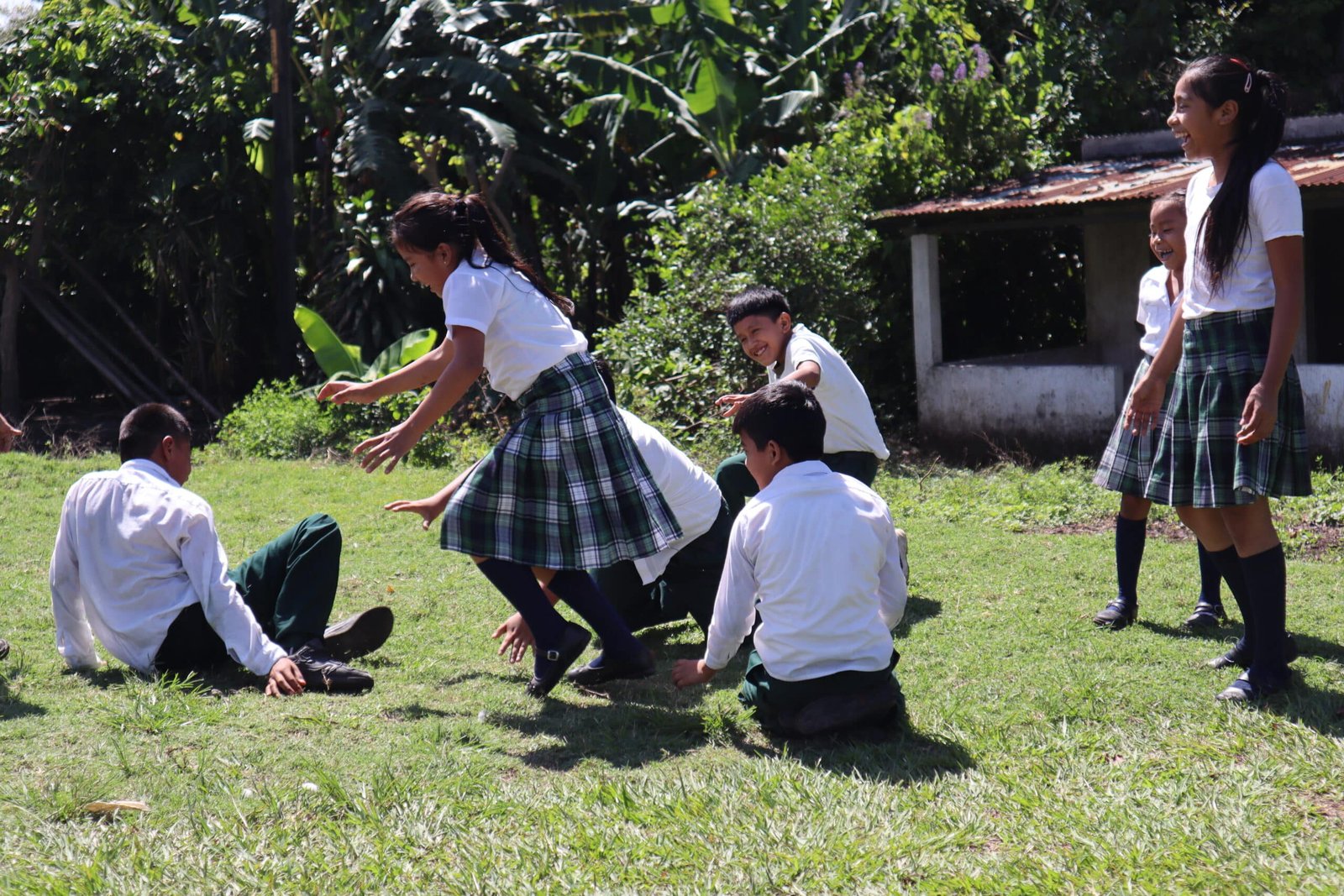 Children playing outside their school, laughing, running, and having fun together