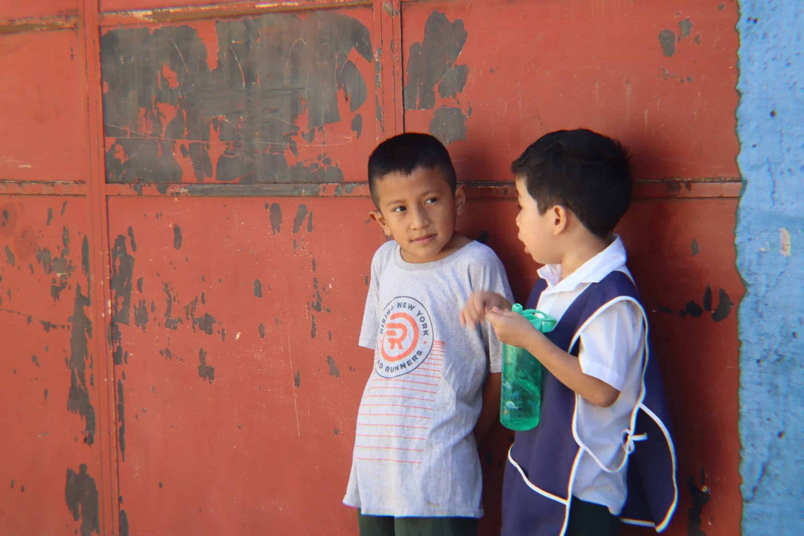 Children playing outside their school, laughing, running, and having fun together