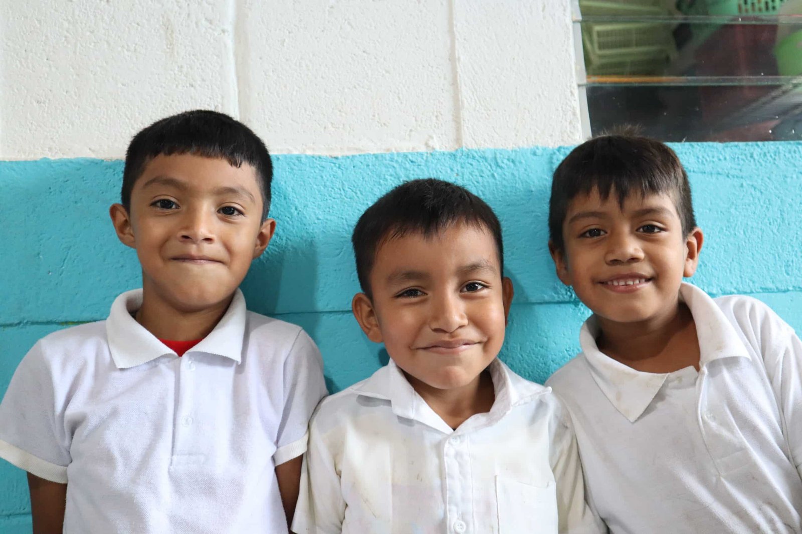 Two children chatting happily in front of the school